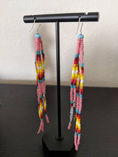 Hand beaded pink, fire-theme earrings with a turquoise stone on top. Sterling silver shepard hooks Fire Theme, Fire Earrings, Pink Fire, Hand Beading, Turquoise Stone, Embroidered Friendship Bracelet, Jewelry Earrings Dangle, Selling On Etsy, Etsy Earrings