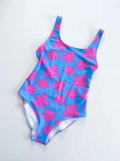 "Not your classic floral print, this is the funkiest floral ever! The \"Flower Sky\" swimsuit, made with one of my latest textile designs, a bold and vibrant print with contrasting colours that won't stay unnoticed at the beach..or anywhere! Instantly doubles up as bodysuit and you're good to go for an afternoon city stroll in the most vibrant flower sky print! - One piece - Low back - Modern floral print - Hugs the body - Easily doubles up as a bodysuit - Double layered chlorine-resistant fabri Colorful Swimwear, Contrasting Colours, Textile Designs, Vibrant Flower, Cute Skirts, Modern Floral, Swimwear Collection, Scarf Hairstyles, Square Scarf