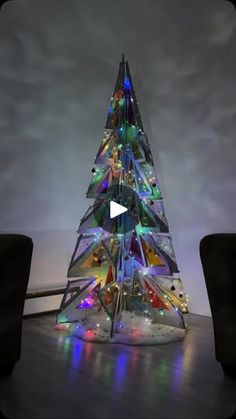 a glass christmas tree sitting on top of a wooden floor