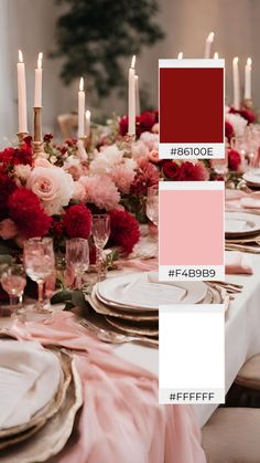 the table is set with pink and red flowers, white plates, silverware, and candles