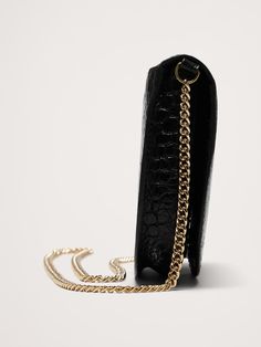 Ideal for day-to-night transitions, we styled this crossbody bag with a metal chain strap that can be tucked inside so you can also carry it as a clutch.  Here, we kept the lines clean as an ode to the season's 90s minimalism, and also to better showcase the beauty of this crocodile-embossed leather.  Magnetic snap closure.  4 card slots and one zippered pocket.  Height: 5" Width: 8" Depth: 1. 4" Chic Travel Phone Bag With Chain Strap, Chic Leather Wallet On Chain With Adjustable Strap, Chic Office Clutch With Mobile Phone Bag, Modern Crossbody Wallet On Chain With Chain Strap, Chic Leather Wallet On Chain For Daily Use, Formal Clutch Shoulder Bag With Cell Phone Pocket, Formal Clutch Bag With Cell Phone Pocket, Chic Formal Wallet On Chain With Adjustable Strap, Formal Rectangular Wallet On Chain With Phone Bag