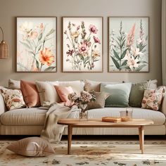 a living room filled with furniture and paintings on the wall above it's coffee table