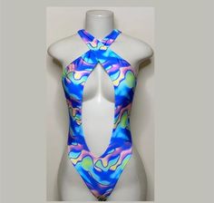 Welcome to my shop Let's Make Money Together 💕 DETAILS  * Handmade Item  * Materials: Nylon, Spandex * Crossover Bodysuit  * Never used  DESCRIPTION  * Thong Bodysuit  * Blue Multi Spandex * 4 way stretch Fabric  * Mannequin is wearing  XS/Small (may choose sizing at checkout) SHIPPING  My current shipping turnaround is really quick 1 to 2 days  RETURNS & EXCHANGES  No refunds or exchanges if you have any issues with your purchase please feel free to reach me personally. I can accommodate on yo Summer Rave Festival Leotard, Summer Festival Rave Leotard, Summer Festival Rave Style Leotard, Blue Rave Swimwear For Summer, Summer Festival Dancewear Bodysuit, Fitted Rave Bodysuit For Beach, Fitted Rave Bodysuit For The Beach, Fabric Mannequin, Club Attire