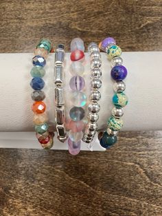 Add a sparkle to your style with Abby's Silver Colour Bracelet Stack! This gorgeous stack of bracelets feature a rainbow of beautiful colors, making it the perfect accessory for any outfit! It's sure to bring a pop of colour to your day! *please note: these bracelets are handmade and the beads vary in colors and shades. You will not receive the exact bracelets that are shown. If you are a HOC client, you can message us with your season and we will do our best to make your bracelet with at least Stacked Bracelets With Round Beads, Spiritual Bracelets With Colorful Beads, Multicolor Bangle Jewelry For Everyday, Multicolor Stacked Round Beads Jewelry, Adjustable Rainbow Stackable Jewelry, Multicolor Stacked Round Bead Jewelry, Everyday Multicolor Bangle Jewelry, Trendy Multicolor Jewelry For Everyday, Bohemian Multicolor Stacked Beaded Bracelets