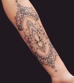 a woman's arm with an intricate tattoo design on the left side of her arm