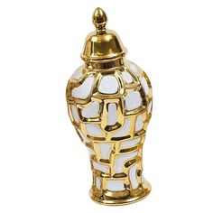 a gold and white vase with a lid on it's side, against a white background