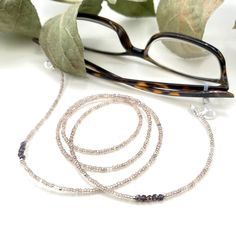 Dainty and bohemian eyeglass necklace chain made with light golden grey with light purple flashes, made with Preciosa Czech crystal seed beads and tiny faceted light purple cubic zirconia beads.    Paired with beautiful silver plated crystal seed beads, this handmade eyeglass chain will definitely create a unique look. This eyeglass lanyard is made on strong quality beading wire with silver plated wire guardians that protect the eyeglass holder grips. The necklace is ended with spring clasps tha Silver Glass Jewelry For Festival, Handmade Silver Glasses Chains For Gift, Handmade Silver Glasses Chains As Gift, Silver Glass Glasses Chains As Gift, Silver Beaded Glasses Chains With Round Beads, Handmade Silver Glasses Chains For Festival, Silver Bohemian Glasses Chains Gift, Silver Glass Glasses Chains For Festival, Elegant Handmade Silver Glasses Chains