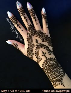 a woman's hand with henna on it