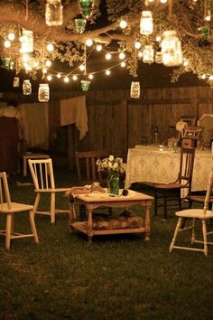 an outdoor dining area with chairs, tables and lights