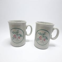 two coffee mugs sitting side by side on a white surface