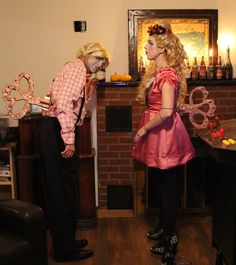 two people dressed up in costumes standing next to each other and looking at each other