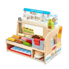 a wooden toy kitchen with lots of food