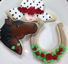 decorated cookies are arranged on a plate to look like cowboy hats and horse head decorations