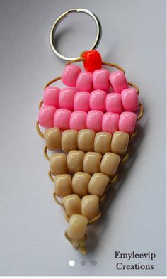 a pink and brown ice cream cone shaped keychain with a red heart on it