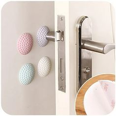 the door handle has three different colored balls on it, and one is in front of an open door