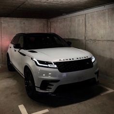 a white range rover parked in a parking garage