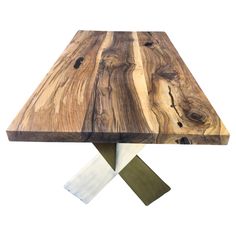 a wooden table with two metal legs and one piece of wood on the top that has been cut in half