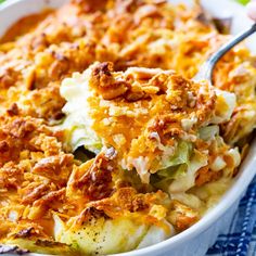 a casserole dish with meat and vegetables in it is being spooned into the casserole