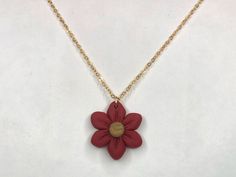 🤍 UNIQUELY HANDMADE JEWELRY 🤍 The Roseanne in Red Necklace is a carefully handcrafted red flower, complete with sparkling gold center, strung on a lightweight 24k gold chain and clasp that is adjustable from 18-20 inches. The simple design is sure to complement any outfit you wear in a beautiful way. Each piece of jewelry is handmade with care, which means no two pieces are alike, even two earrings can have slight differences, which is what makes handmade so truly unique and special!! While polymer clay is quite durable, care must be taken to preserve it long term. Please be careful to not bend, flex or drop the jewelry.  We recommend removing our jewelry before showering, swimming or sleeping as well as storing in a safe, dry location.  If your earrings arrive damaged or broken, we will Handmade Red Flower Necklace Adjustable, Handmade Adjustable Red Flower Necklace, Handmade Red Flower Necklace With Adjustable Fit, Adjustable Red Jewelry With Flower Charm, Handmade Red Flower Jewelry, Handmade Rose Gold Flower Necklace, Red Adjustable Flower Necklace, Handmade Red Flower Necklace, Handmade Rose Red Flower Jewelry