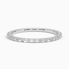 a white gold wedding band with baguetts set in the middle and diamonds on each side