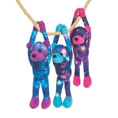 three stuffed monkeys hanging from a rope with space in the background and stars on them