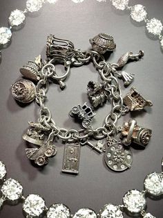 Thank you for viewing Wrenn Estate. Spectacular Wedding themed charm bracelet. 6 of them open! 4 have movable parts! Toggle clasp. Fantastic wedding gift! 7 1/2 inches Bird in a cage, opens Baby in a basket, opens Stork with baby, moves Wedding bells Home, opens I love you phone dial, moves Telephone Carriage, opens Door and key Baby in carriage, moves Carousel, moves Wedding cake, opens Wedding cake with enamel bride and groom, opens 66.42 grams sterling silver Affordable Silver Bracelet With Vintage Charm, Elegant Silver Wedding Charms, Elegant Wedding Charms With Vintage Style, Elegant Hallmarked Charms For Collectors, Elegant Wedding Charms With Vintage Design, Sterling Silver Round Charm Bracelet For Wedding, Elegant Vintage Wedding Charms, Victorian Style Bracelet With Vintage Charm For Gift, Victorian Bracelets With Vintage Charm As Gift