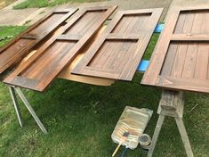 several pieces of wood sitting on top of a grass covered field