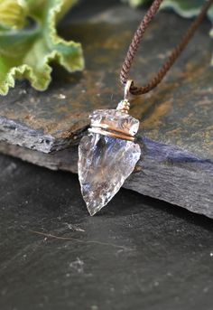 "This Crystal Quartz Arrowhead necklace is handmade with white brass in a technique called wire wrapped. This healing stone is known as the \"master healer\" and will amplify energy and thought, as well as the effect of other crystals. It absorbs, stores, releases and regulates energy. Clear Quartz draws off negative energy of all kinds, neutralising background radiation, including electromagnetic smog or petrochemical emanations. I feel deeply in love with this design because this is the first Handmade Sterling Silver Arrowhead Necklace, Artisan Hand Wrapped Pendant Crystal Necklaces, Bohemian Arrowhead Jewelry As A Gift, Healing Quartz Wire Wrapped Jewelry, Artisan Hand Wrapped Pendant Crystal Necklace, Bohemian Arrowhead Jewelry Gift, Bohemian Arrowhead Jewelry As Gift, Bohemian Jewelry With Raw Quartz Stone, Bohemian Quartz Jewelry With Raw Stone