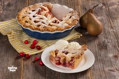 an apple pie with cranberries on a wooden table