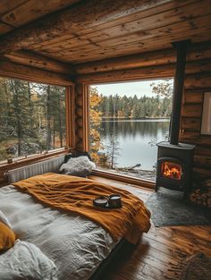 a bed in a room with a window and a fire place next to the bed