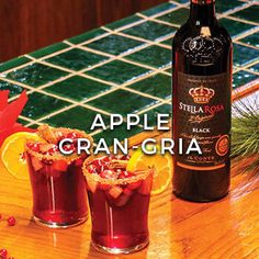 an advertisement for apple cran - gria, with two glasses filled with fruit