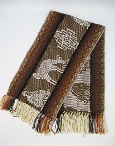 This beautiful Alpaca wool scarf is woven from Alpaca wool blend with llama and chakanas design. This scarf is originally made from local makers in Cusco - Peru. This beautiful scarf is a perfect cozy gift for your love one. Features: * Made from Alpaca and acrylic yarn. Measurements: 62 inches (L) x 9.5 inches (W) Dry clean or hand wash gently in cold water with mild detergent - dry flat - no machine dryer Traditional Brown Shawl With Woven Motifs, Bohemian Alpaca Scarves For Winter, Traditional Woven Winter Shawl, Brown Traditional Patterned Scarves, Traditional Brown Shawl For Winter, One Size Handwoven Alpaca Shawl, Traditional Alpaca Shawl One Size, Brown Alpaca Shawl, Bohemian Brown Handwoven Scarves