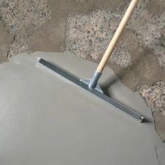 a mop laying on top of a cement block