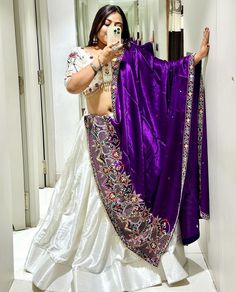 Step into the festive season with this stunning Chaniya Choli set, perfect for Navratri celebrations. This ensemble features an exquisite combination of white and purple hues, crafted from luxurious chinon fabric, and adorned with intricate embroidery and sequins. Product Features: Fabric: Chinon fabric, known for its smooth texture and elegant drape. Design: The choli features heavy embroidery and sequins work, creating a dazzling effect that is sure to make you stand out. Colors: A sophisticated combination of white and purple hues that exudes elegance and festivity. Sizes Available: Medium (M): Size 38 Extra Large (XL): Size 42 Occasion: Perfect for Navratri, Garba nights, and other festive occasions. Comfort Fit: Designed for comfort while maintaining a stylish look. Dupatta: The set i Purple Chaniya Choli, Sequence Lehenga, Cotton Lehenga, Navratri Chaniya Choli, Stitched Lehenga, Bollywood Lehenga, Saree Gown, Navratri Special, Heavy Embroidery