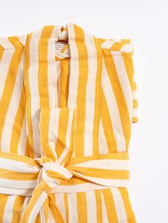 Add a touch of sunshine to your daily routine with the Girit Yellow Robe. This bright and cheerful robe, crafted from a soft cotton-linen blend, features bold yellow and white stripes, bringing a warm and vibrant feel to your mornings, spa sessions, or relaxation time. Perfect for lounging at home, by the pool, or as a stylish cover-up after a shower. The Girit Yellow Robe is designed for a comfortable and flattering fit. It is handwoven on semi-automated looms, showcasing traditional craftsmans Yellow Spring Sleepwear For Vacation, Summer Cotton Robe For Daywear, Yellow Summer Sleepwear For Vacation, Yellow Summer Vacation Sleepwear, Yellow Cotton Sleepwear For Spring, Striped Sleepwear For Summer Vacation, Yellow Cotton Sleepwear For Summer, Spring White Cotton Robe, Summer Beach Robe In Yellow