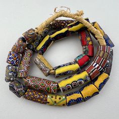 A strand of old Venetian - mostly millefiori - trade beads. Late 1800's to early 1900's. 31 beads 26" of beads 66cm 13 to 14mm diameter 2mm hole Antique Multicolor Handmade Beads, Antique Handmade Multicolor Beads, Antique Style Handmade Multicolor Beads, Antique Round Spacer Beads, Antique Multicolor Beaded Necklaces, Antique Multicolor Beaded Necklaces With Round Beads, Antique Hand-strung Oval Beads, Hand-strung Antique Oval Beads, Vintage Yellow Polished Beads