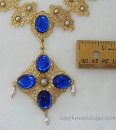 Wear a piece of history with this "Mary, Queen of Scots" movie-inspired reproduction Tudor necklace. Crafted with ornate gold-tone filigrees and captivating acrylic cabochons, this regal accessory adds unique glamor to any look. Necklace length is 17-18", with a 2-3" extender attached. Longer and shorter lengths available upon request, message me with your desired length. Medieval Necklace, Queen Of Scots, Collar Necklaces, Mary Stuart, Mary Queen Of Scots, Necklace Collection, Collar Necklace, Handcrafted Jewelry, Wedding Jewelry