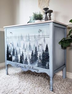 a painted dresser with pine trees on it and the words want to be merry written in black ink