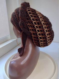 a crocheted hat on top of a mannequin head