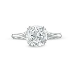 a white gold ring with a round cut diamond