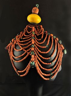 Rare original Eastern Himalayan headdress of a type that is worn in Bhutan. Tongs of metal covered with fabric have attached coral and turquoise beads. A top knot style finial of faux amber (Bakelite), a silver decorative cap and a large coral top bead stopped with turquoise is a take on various Tibetan and Chinese official finials found on headdresses. The draped coral strands are attached in levels to create a very beautiful effect. Early 20th century. Traditional Red Coral Jewelry With Wooden Beads, Traditional Red Beads With Bead Caps, Orange Bohemian Red Coral Beads, Bohemian Orange Red Coral Beads, Coral Top, Bhutan, Tongs, Top Knot, Turquoise Beads