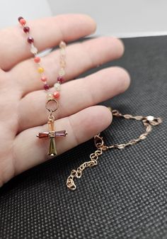 Add a splash of color and spirituality to your accessory collection with our handmade multicolor beaded cross necklace. This unique piece is meticulously crafted with a variety of autumn-toned beads, creating a vibrant and eye-catching design. The delicate cross pendant features a mix of colors (burgundy, yellow, orange, green, purple, coral and white) that perfectly complements the beaded chain, making it a versatile and meaningful accessory. Features: Materials: High-quality beads in autumn to Multicolor Beaded Cross Jewelry, Multicolor Wire Wrapped Necklace For Gift, Cross Shaped Beaded Chain For Jewelry Making, Cross-shaped Beaded Chain For Jewelry Making, Spiritual Wire Wrapped Cross Pendant Necklace, Beaded Cross Pendant For Jewelry Making, Spiritual Beaded Cross Pendant Necklace, Handmade Multicolor Cross Jewelry, Handmade Multicolor Cross Necklace