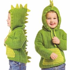 a young child wearing a green knitted dinosaur hoodie and matching blue jean shorts