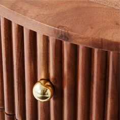 a close up of a wooden cabinet with brass knobs