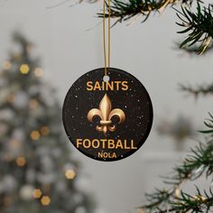 an ornament hanging from a christmas tree with a football team logo on it