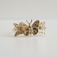 "With brave wings, she flies..."The "Butterfly Hope ring" ring is inspired by the beauty and endurance of butterflies. It symbolizes personal transformation, hope, and rebirth. Three gold butterflies sit on a 14K solid gold band, embellished with your choice of tiny white diamonds. Handcrafted in 14K solid yellow gold, rose gold and white gold. 14K solid gold Natural round white diamonds. SI clarity. Approx 0.035ct 1.2mm ring band **This item is specially made for you. Please allow 1-2 week lead With Brave Wings She Flies, Brave Wings, Personal Transformation, Solid Gold Band, Gold Butterfly, Cute Necklace, The Butterfly, Ring Ring, Gold Band