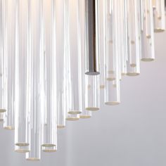 a modern chandelier with glass tubes hanging from the ceiling