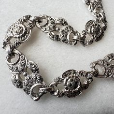 A beautiful classic Marcasite Bracelet, lovely gift idea! Dating from circa 1950's. *It is Silver Tone (in colour) but not Sterling Silver. The Metal is not precious metal. * Marcasite Deatiling  * Length (when open & laid flat) 18cm.  * Closure is a Spring Ring. The closure looks not to be original but still works perfectly fine. Bracelet Condition - Excellent - No Flaws to Note - Just the closure as mentioned above (priced with this in mind) Thanks for looking! Fine Bracelet, Marcasite Bracelet, Idea Birthday, Precious Metal, Jewelry Inspo, Charm Bracelets, Spring Rings, Precious Metals, Lovely Gift