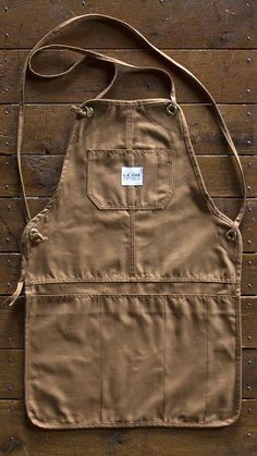 a brown apron sitting on top of a wooden floor