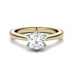 a yellow gold engagement ring with a single diamond